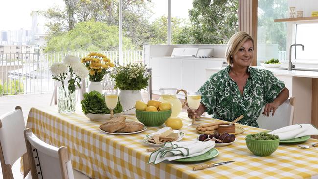 Chyka Keebaugh and her Harris Scarfe homewares range - the Chyka Gingham Tablecloth 180 x 230cm Mustard, the Sugar Snap Peas 30cm x 21cm Oval Plate, the Sunday Dinner Plate 26.8cm Green, the Monkeys Garden Bamboo Cutlery Set, the Sunday Cereal Bowl 15cm Green and the Home Scalloped Dinner Plate. Photography: Louise Roche Styling: Kylie Jackes