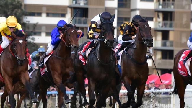 Here To Shock (middle) beats Freedom Rally (inside) to a Stradbroke Handicap golden ticket. Picture: Grant Peters — Trackside Photography.