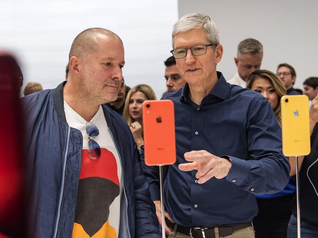 Tim Cook, chief executive officer of Apple Inc., right, and Jony Ive, chief design officer for Apple Inc., view an iPhone XR smartphone during an event at the Steve Jobs Theater in Cupertino, California, U.S., on Wednesday, Sept. 12, 2018. Apple Inc. took the wraps off a renewed iPhone strategy on Wednesday, debuting a trio of phones that aim to spread the company's latest technology to a broader audience. Photographer: David Paul Morris/Bloomberg