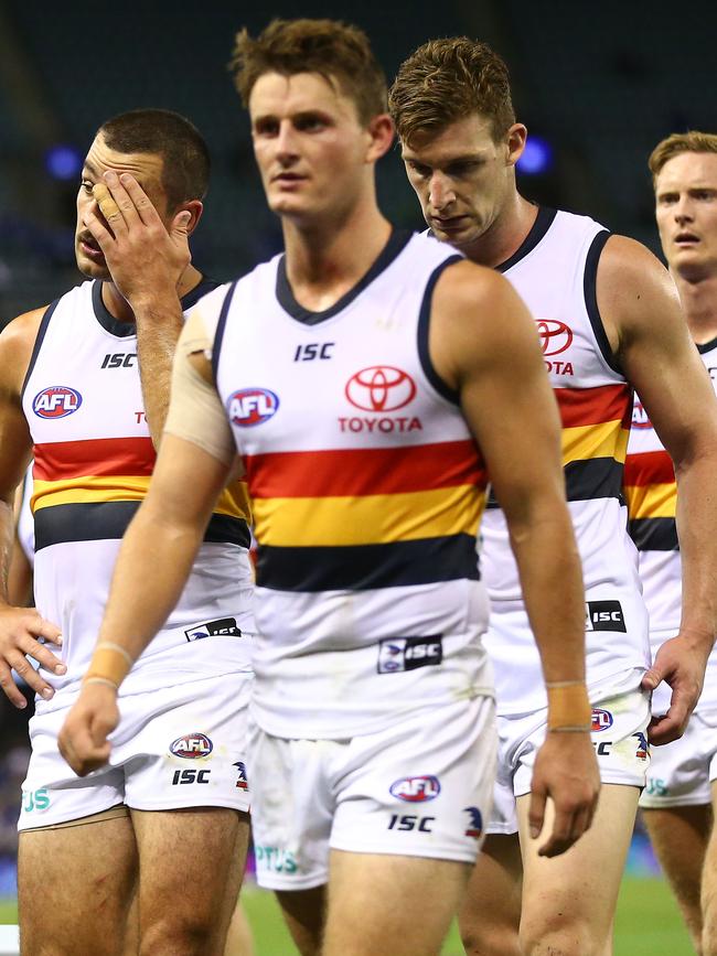 Crows co-captain Taylor Walker leads his disappointed teammates off Marvel Stadium on Saturday night. Picture: Scott Barbour/Getty Images