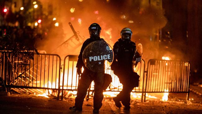 Police stand by burning barricades in front of the White House during a protest. Picture: AFP