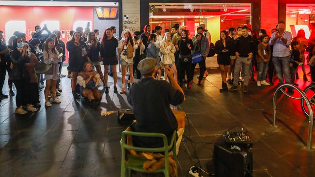 People watch a street performer earlier in the night. Picture: Getty