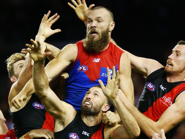 MELBOURNE, VICTORIA - APRIL 29: Max Gawn of the Demons (C) compete for the ball over Cale Hooker and Matthew Leuenberger of Essendon (R)  during the round 6 AFL match between the Essendon Bombers and Melbourne Demons at Etihad Stadium on April 29, 2018 in Melbourne, Australia.  (Photo by Michael Dodge/AFL Media/Getty Images)