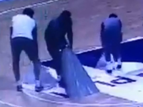 Australian team officials remove floor decals. Picture: Twitter