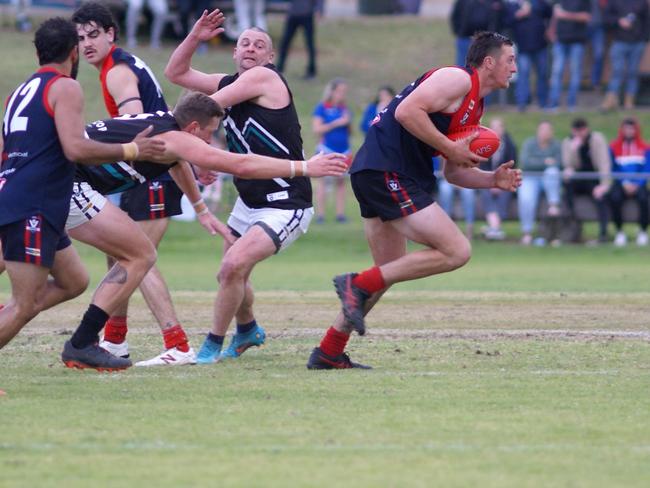 Swifts Creek's Conor Harvey bursts away from the pack against Omeo-Benambra. Picture: Jason Darby