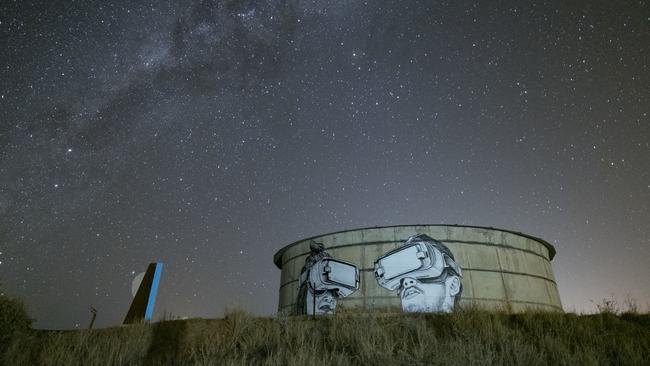 A night scene showing VR goggles artwork projected on to a water tank in the West Pilbara ghost town of Cossack. Picture: Russell Ord Photography (www.russellordphoto.com)