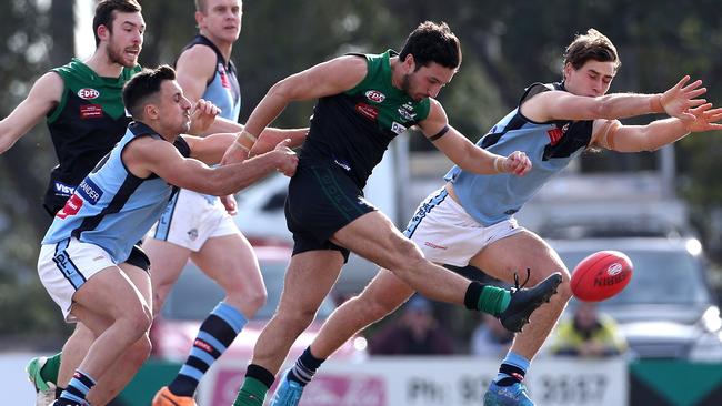 Greenvale’s Daniel Micevski gets a kick away while under pressure from Rhys Moylan (left) and Caleb Hislop. Picture: Hamish Blair