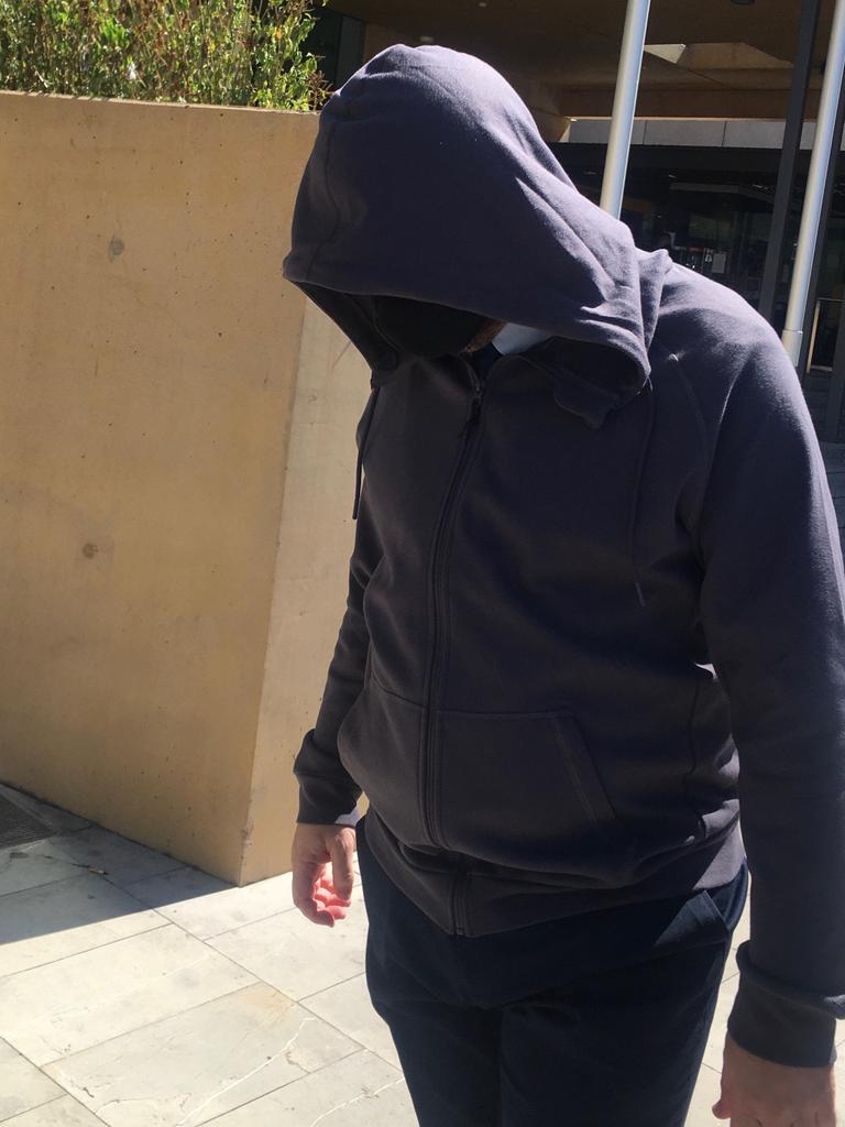 Justin Troy Owen hid his face as he left court.