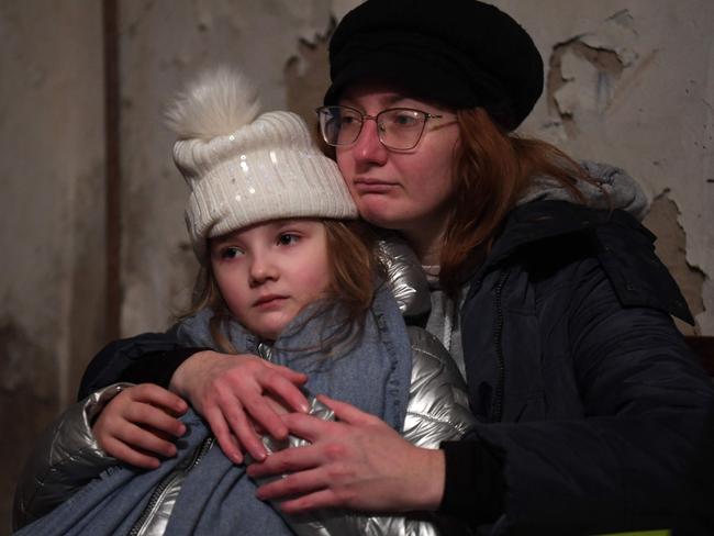 Helga Tarasova hugs Kira Shapovalova as they wait in an underground shelter during a bombing alert in the Ukrainian capital of Kyiv. Picture: AFP