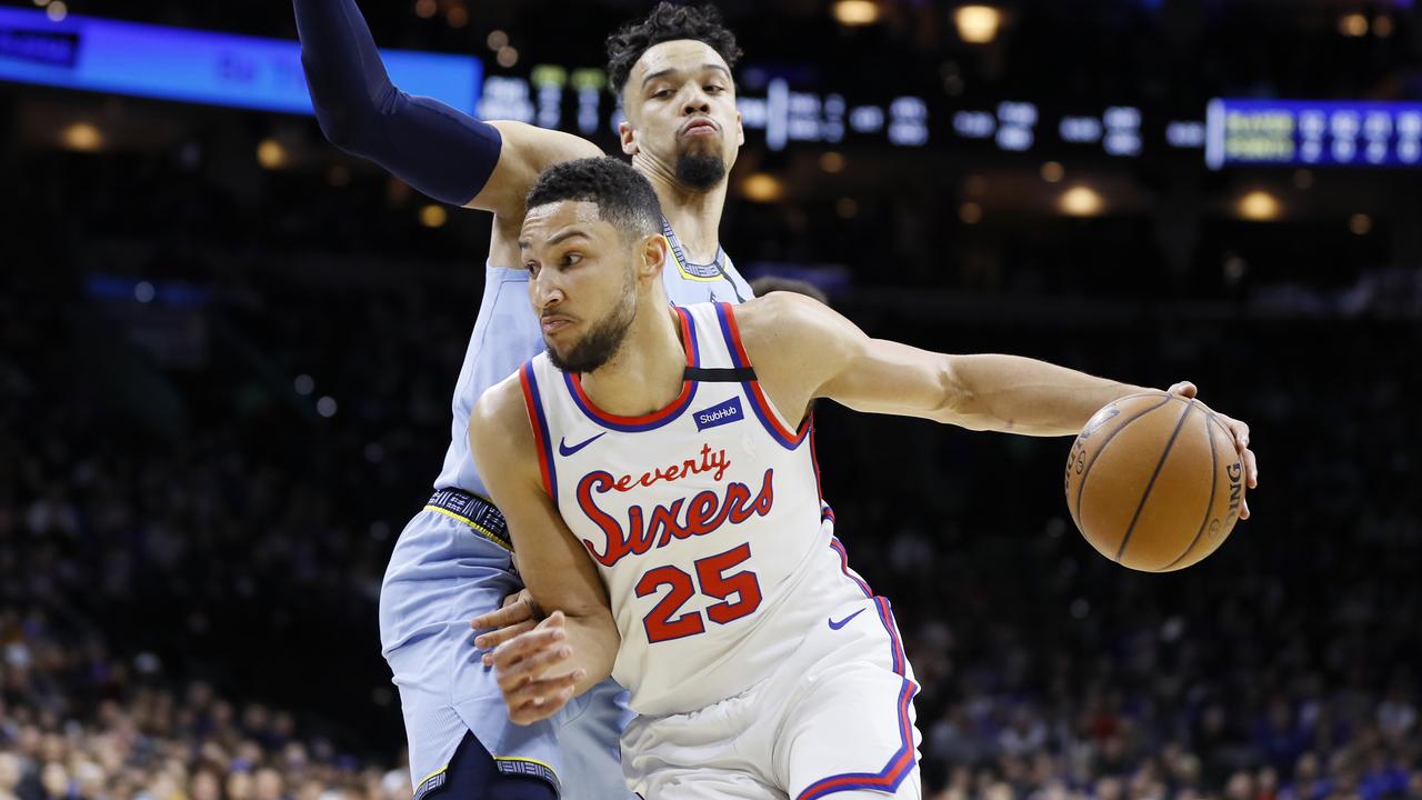 Philadelphia 76ers' Ben Simmons, front, dribbles past Memphis Grizzlies' Dillon Brooks during the first half of an NBA basketball game Friday, Feb. 7, 2020, in Philadelphia. (AP Photo/Matt Slocum)