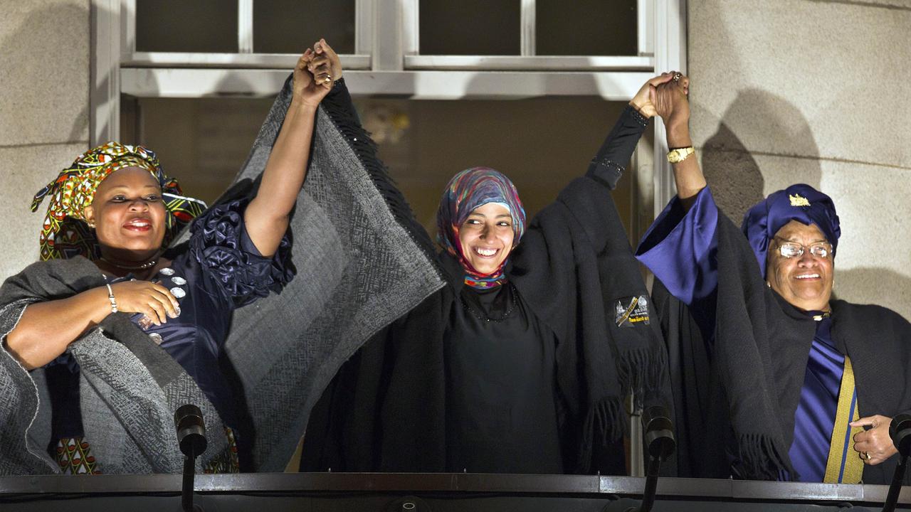 Nobel Peace Prize 2011 laureates (L-R) Liberian 'peace warrior' Leymah Gbowee, Yemeni activist Tawakkul Karman, and Liberian President Ellen Johnson Sirleaf acknowledge the crowd from the balcony of the Grand Hotel in Oslo, Norway after receiving their prize during an award ceremony at the city hall.