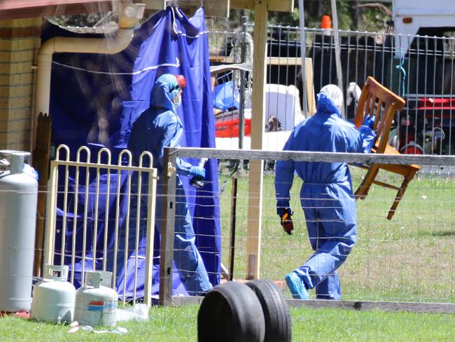 Police remove a chair from the Thorburns’ Chambers Flat house. Picture: Darren England