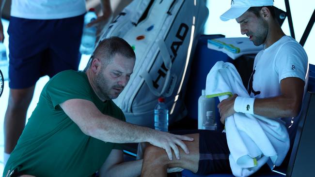 Novak Djokovic receives treatment on his knee. Picture: Graham Denholm/Getty Images