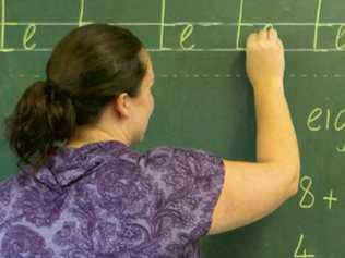 03/03/2011 EDUCATION: 03/03/2011 EDUCATION: Generic photo of a teacher writing on a blackboard in a classroom.