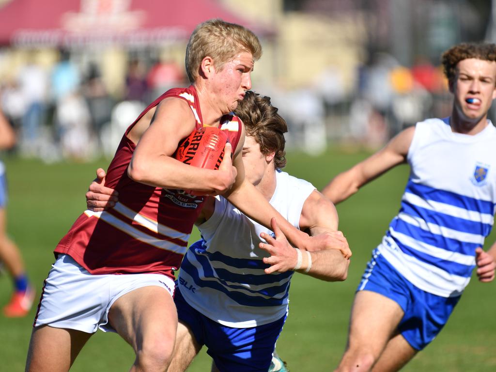 PAC’s Jack Heard tries to break clear of a St Peter’s opponent in their intercol game. Picture: AAP/ Keryn Stevens.