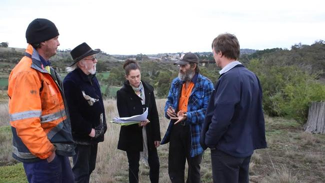 Uncle Dave Wandin (fourth from left) and representatives discuss the restoration of the Sunbury Rings.