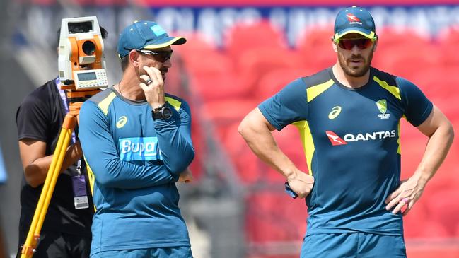 Finch (R) with team coach Justin Langer. Picture: AFP