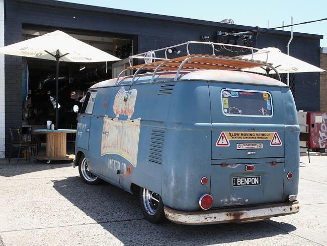 A classic Volkswagen Kombi van out the front of the cafe. 