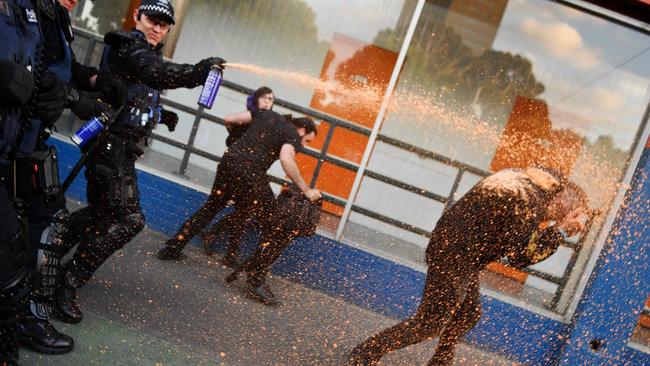 Police use pepper spray to disperse protesters outside Milo Yiannopoulos’s speech last night. Picture: Jake Nowakowski