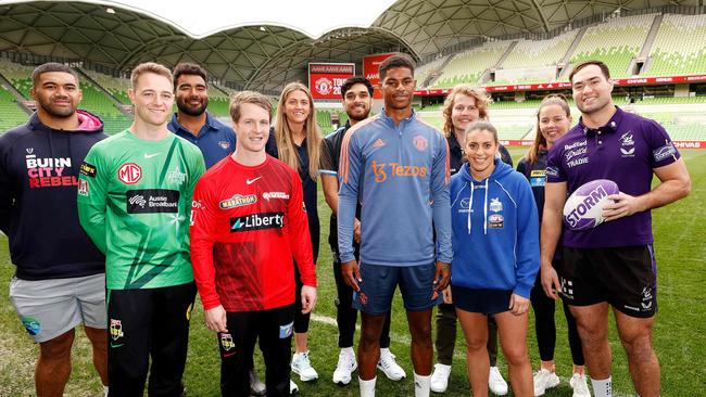 Manchester United's Marcus Rashford poses for a photo with members of Melbourne’s sporting clubs. Photo by CON CHRONIS / AFP.