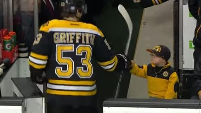 Adorable kid fist bumps entire team