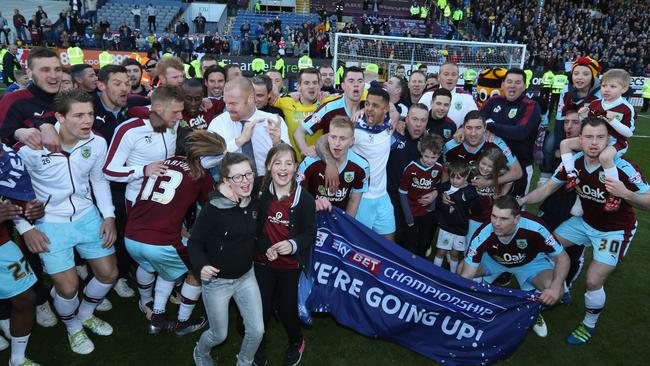 Burnley players and staff celebrate as they are promoted to the Premier League.