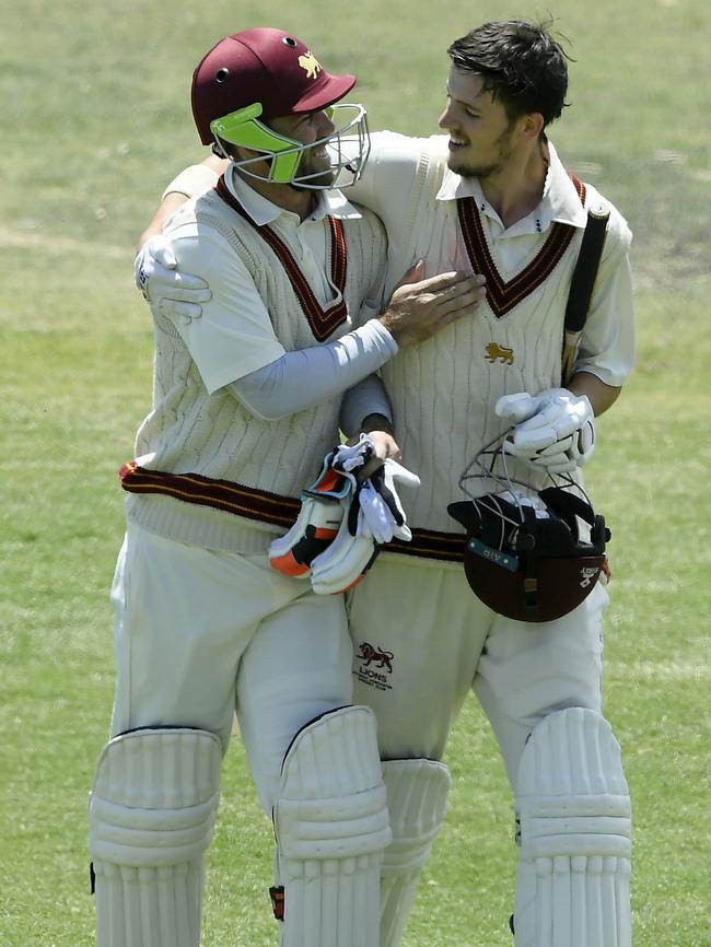 Glenn Maxwell leaves the field with Fitzroy Doncaster teammate Zach Elliott during his cricket return.