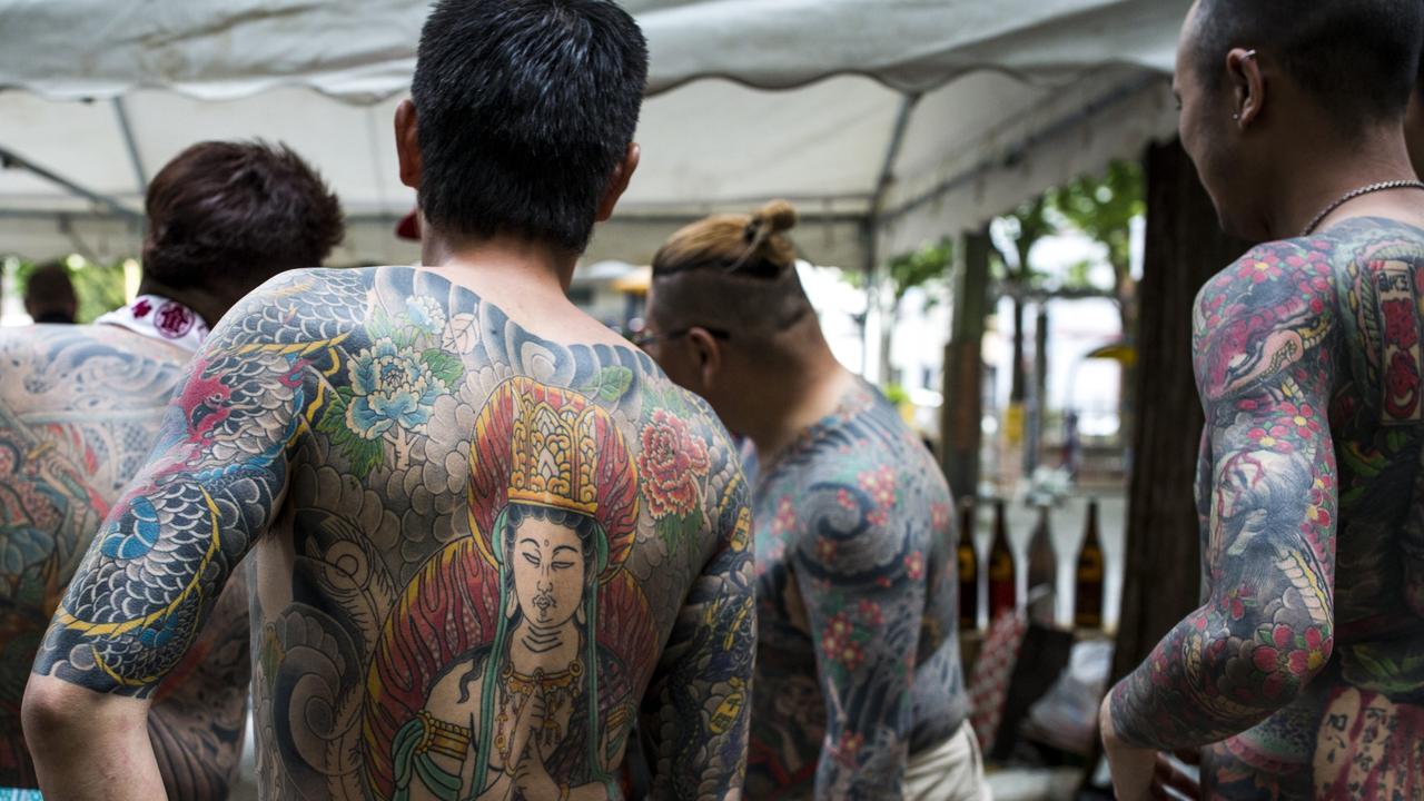 Yakuza members proudly display their tattoos during the second day of the Sanja Matsuri Festival in Tokyo's Asakusa district in 2016.