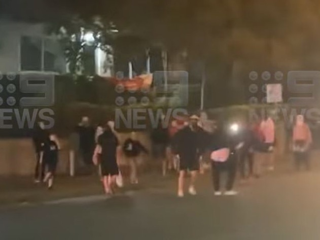 A large crowd pictured on the road outside the McDonald's at Christine Ave in Robina on Saturday May 6 as police conducted an operation targeting hoons in the area. Picture: Nine Gold Coast News.