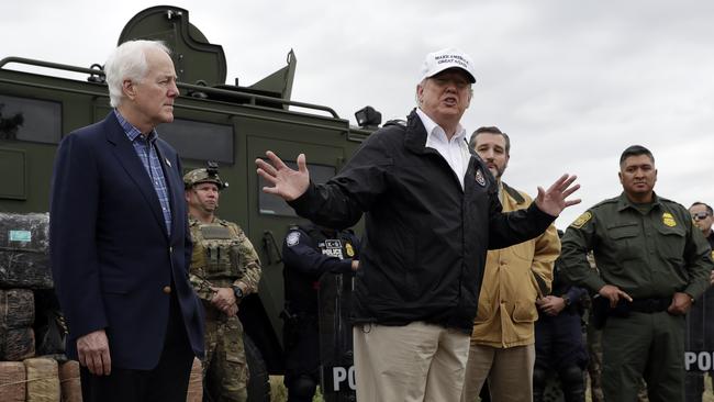 Donald Trump flanked by Texas senators John Cornyn, left, and Ted Cruz at the border at Rio Grande yesterday. Picture: AP