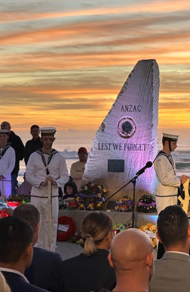 The Last Post – by bugler Dr Richard Thompson of the Gold Coast City Brass Band – rang out in the cool morning air as the crowd listened on in stoic silence. Surfers Paradise. Photo: Ryan Keen