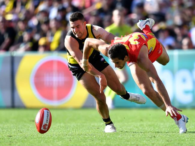 Jack Graham of the Tigers (left) and Michael Rischitelli of the Suns contest the loose ball during the Round 21 AFL match between the Gold Coast Suns and the Richmond Tigers at Metricon Stadium on the Gold Coast, Saturday, August 11, 2018. Picture: AAP Image/Darren England