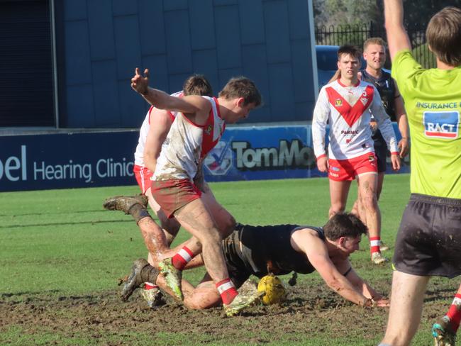 Players compete for the ball in the Windsor Park mud. Picture: Jon Tuxworth