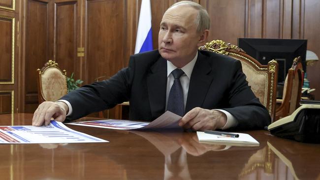 Russian President Vladimir Putin listens to Moscow Mayor Sergei Sobyanin during their meeting at the Kremlin in Moscow, Russia, Monday, May 5, 2025. (Vyacheslav Prokofyev, Sputnik, Kremlin Pool Photo via AP)