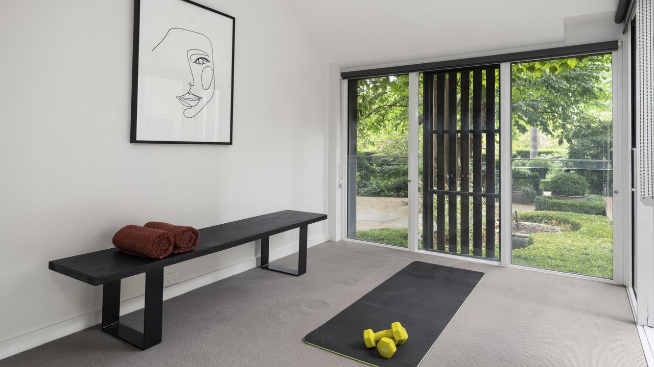 This private home gym and studio space offers a wellness retreat complete with a bathroom.