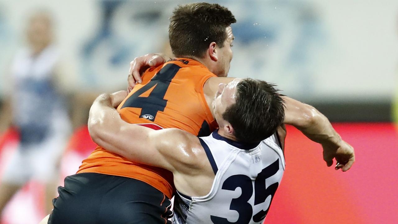 GEELONG, AUSTRALIA - AUGUST 06: Toby Greene of the Giants hits Patrick Dangerfield of the Cats high in an attempt the fend off a tackle during the round 21 AFL match between Geelong Cats and Greater Western Sydney Giants at GMHBA Stadium on August 06, 2021 in Geelong, Australia. (Photo by Darrian Traynor/Getty Images)