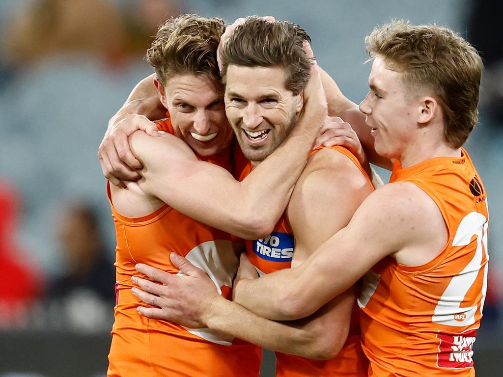 Lachie Whitfield, Callan Ward and Harvey Thomas of the Giants celebrate a goal. Picture: Michael Willson/AFL Photos via Getty Images.