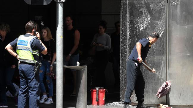 Assain cleans the public toilet with police backup. Picture: Nicole Garmston