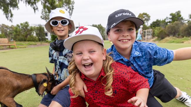 James Carbone, 8, (Mini International DJ Fisher) with Ambrose Skrypek, 8, (Mini Ripper GC Cam Smith) and David Cooper, 8 getting ready to party with Tinkerbell the goat at the Liv Golf Family Fairway Media Call at Grange Golf Club, Adelaide. Picture: Kelly Barnes