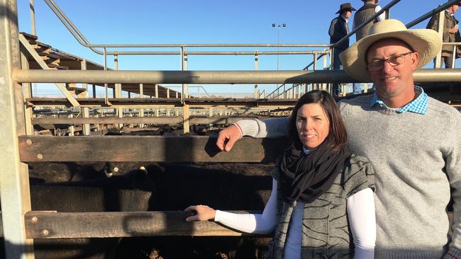 Julie and Jeremy Shaw of JS Grazing watching their family's Angus-cross steers sell at a Roma Store Sale.