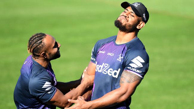 Justin Olam and Tui Kamikamica share a laugh during a Melbourne Storm NRL training session. Pictures: Bradley Kanaris/Getty Images