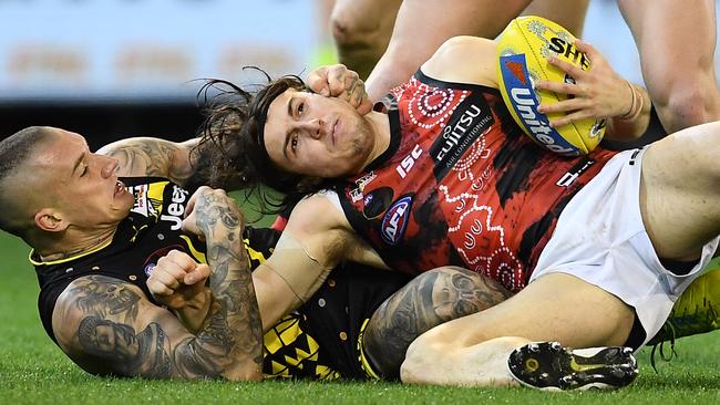 MELBOURNE, AUSTRALIA - MAY 25: Dustin Martin of the Tigers tackles Andrew McGrath of the Bombers during the round 10 AFL match between the Richmond Tigers and the Essendon Bombers at Melbourne Cricket Ground on May 25, 2019 in Melbourne, Australia. (Photo by Quinn Rooney/Getty Images)