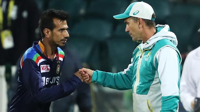 Yuzvendra Chahal and Justin Langer bump fists after the match. Picture: Mark Kolbe/Getty Images