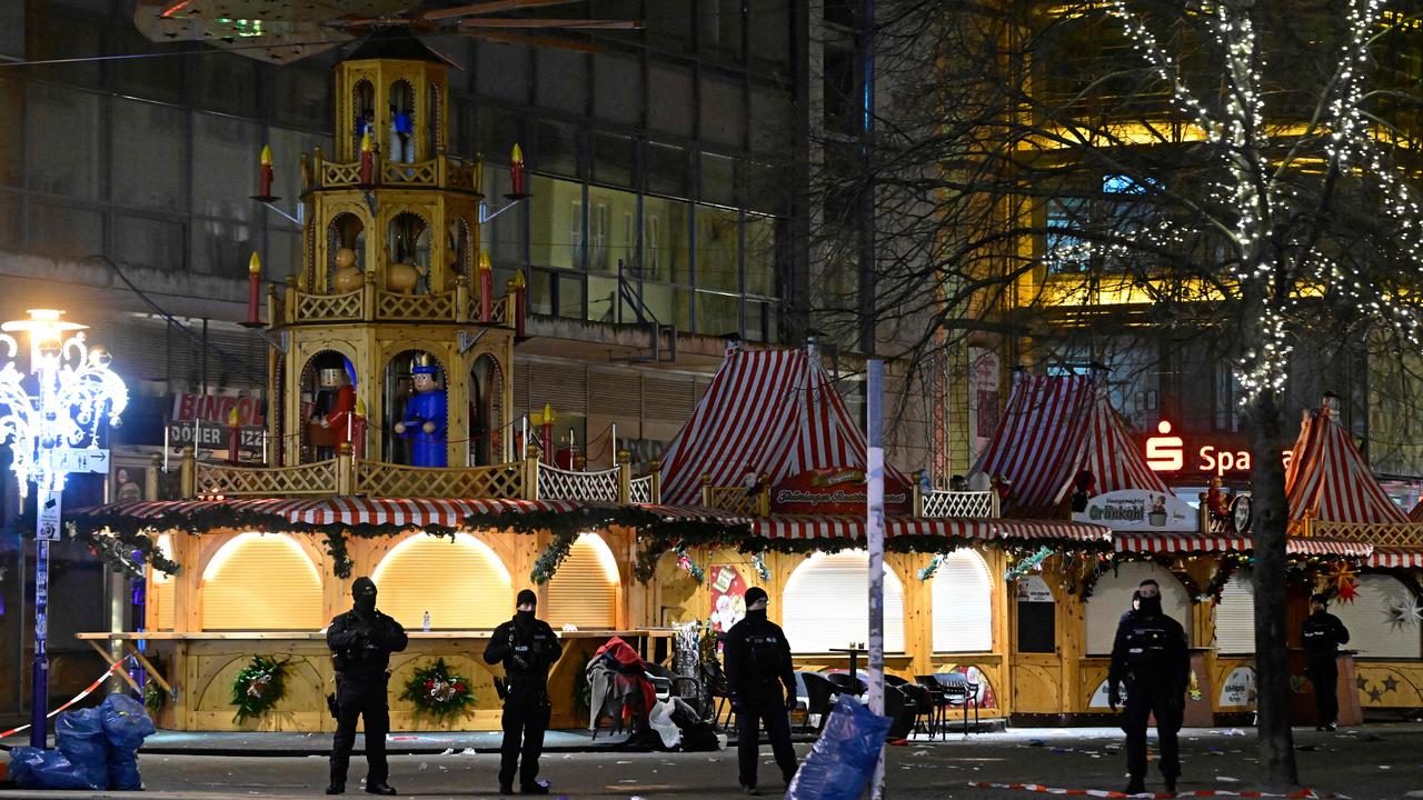 Security forces members stand guard at the entrance of a Christmas market. Picture: John Macdougall/AFP