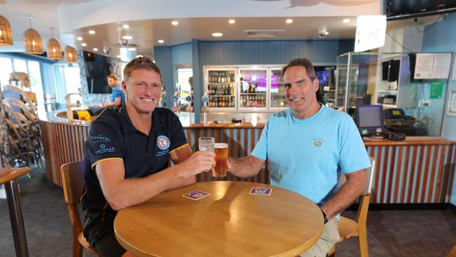 Surfers SLSC President Trevor Hendy toasts new renovations with Supporters Club president Jon Neilsen. Clubs will get a budget boost. Picture: Glenn Hampson.