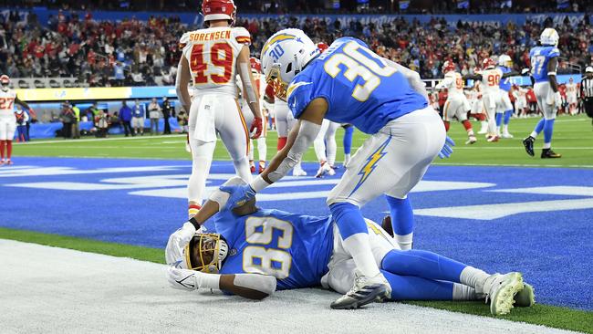 Austin Ekeler checks on teammate Donald Parham. Photo: Kevork Djansezian/Getty Images/AFP