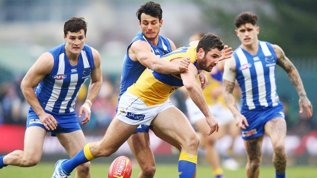 North Melbourne defenders Scott Thompson, Robbie Tarrant and Marley Williams shut down Jack Darling.