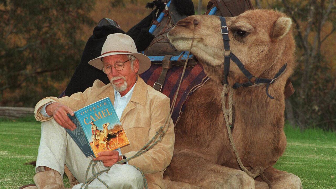 Outback adventurer Rex Ellis holding his book 