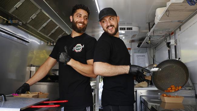 Ramzy Shublaq and Roby Sawan whip up some Palestinian fare Stripped Gaza Street Food truck. Picture: Jonathan Ng