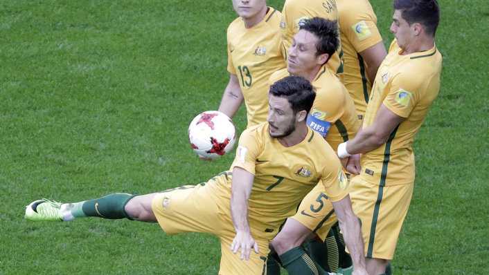 Australia's Mathew Leckie, foreground, intercepts a free kick during the Confederations, Cup Group B soccer match between Cameroon and Australia, at the St.Petersburg stadium in St.Petersburg, Russia, Thursday, June 22, 2017. (AP Photo/Dmitri Lovetsky). Picture: Dmitri Lovetsky